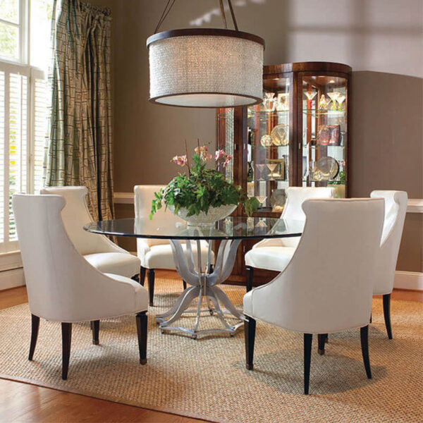 round dining table in warm lighting with four white chairs