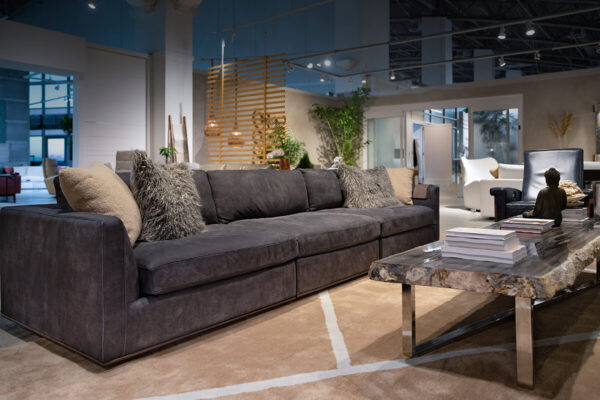 Siena sofa staged in charcoal contemporary three seat sofa with neutral accessories by American Leather
