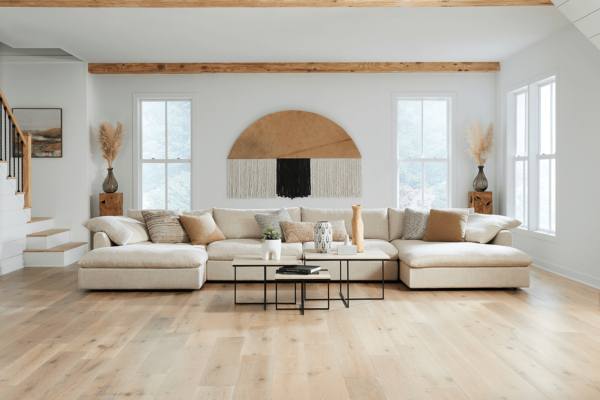 wide angel shot of beige modern sectional in neutral living room