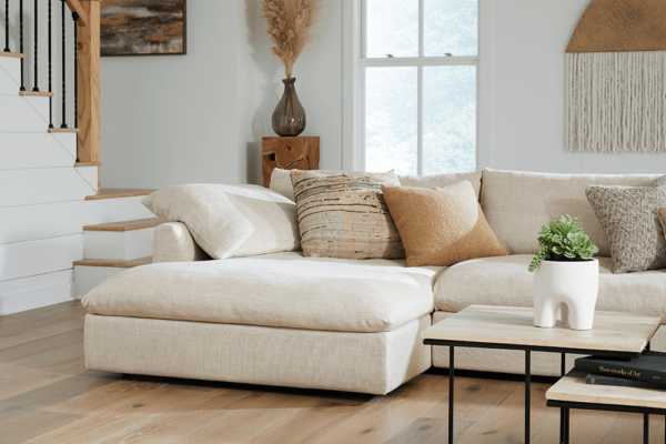 closeup shot of beige modern sectional corner with neutral pillows