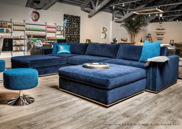 contemporary electric blue sectional with chaise and an aqua welt and stainless steel base