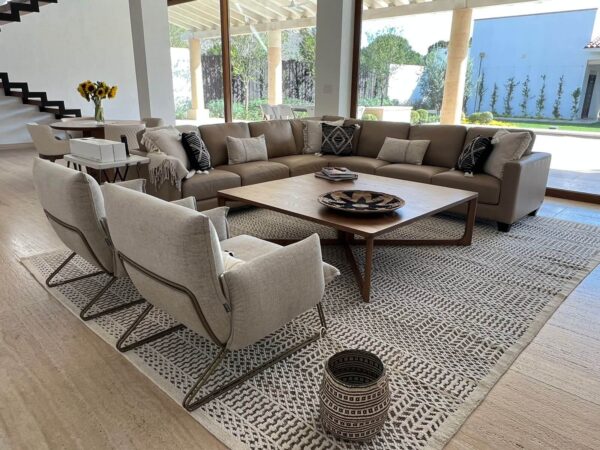 empty contemporary and neutral toned living room space featuring two fabric Margot accent chairs by Gamma designed by Niu Urban Living