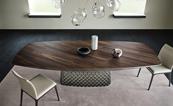 Cattelan Italia's Atrium Masterwood dining table burned oak wooden carved top and metal quilted base top view in an empty dining room.