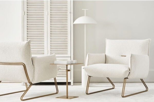 two sleek and modern Margot accent chairs by Gamma in a textured white fabric showing front and back at an angle
