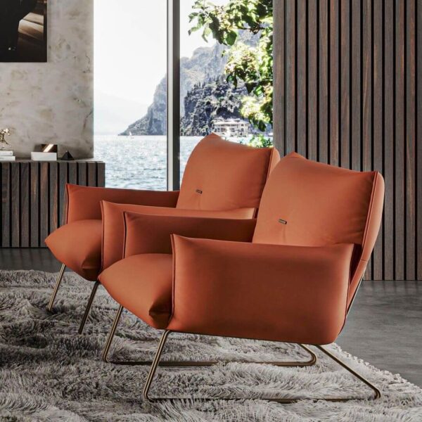 two sleek and modern Margot accent chairs by Gamma in a solid burnt orange leather showing the side profile in a contemporary space.