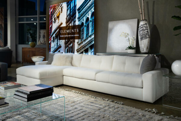 white sofa chaise Montera by American Leather from Elements collection in a dimly lit moody room available in McAllen, TX at Niu Urban Living furniture store.